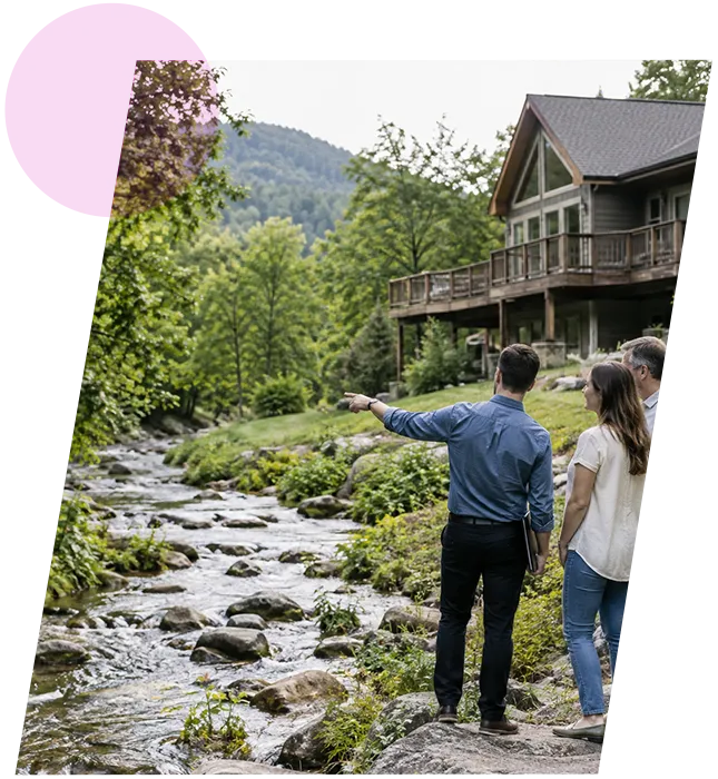 Real estate buyer showing a couple a scenic wooded property near a creek during valuation.