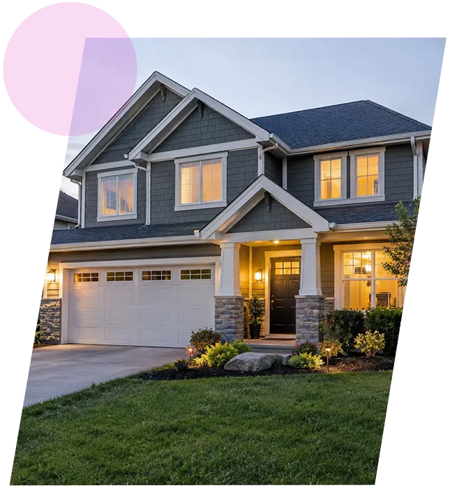 Modern two-story suburban house with exterior evening illumination and attached garage in Middletown, KY.