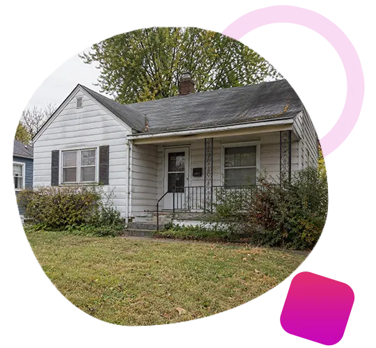 Modest single-story white house with a covered front porch and lawn in Jeffersonville, IN.