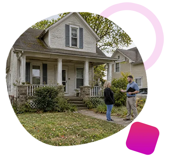 Home evaluator speaking with a female homeowner on the sidewalk outside an older La Grange, Kentucky house.