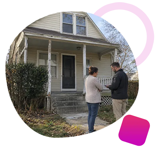 Real estate specialist with clipboard evaluating a one-story brick house alongside a Mount Washington homeowner.