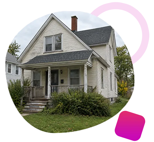 Older two-story white house with peeling siding and overgrown bushes in Albany, IN.