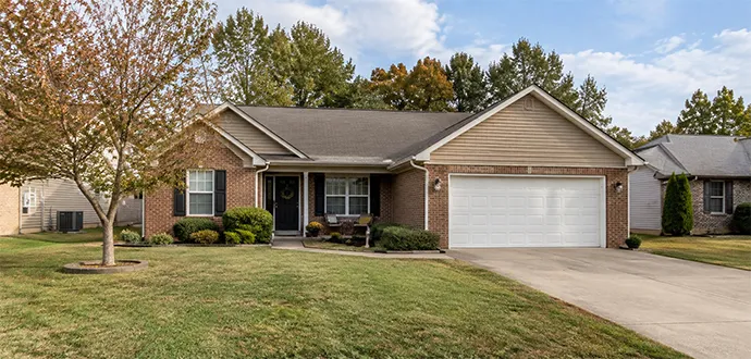 Single-story brick and vinyl ranch home with an attached garage and front lawn in Shepherdsville, Kentucky.